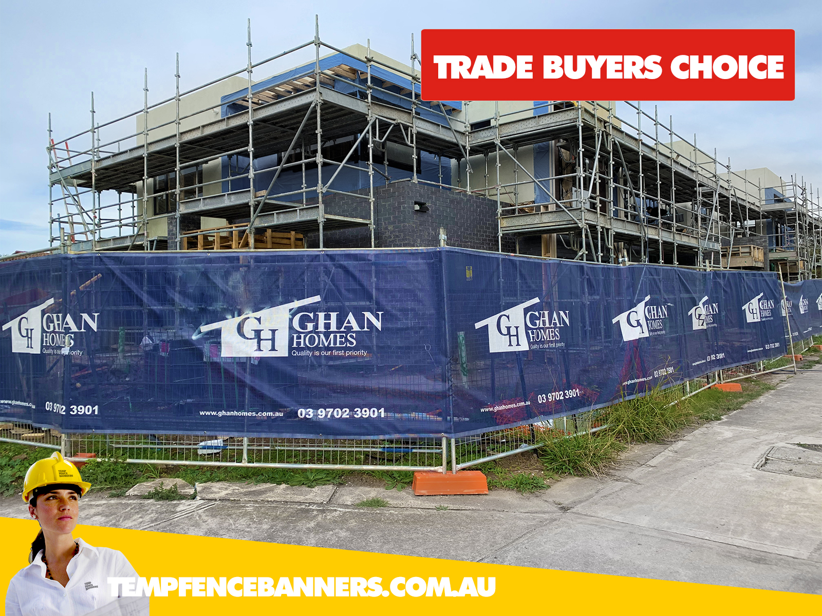 Large building site with printed blue mesh insignia on the temp fence hire banner during construction